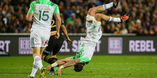 Highlanders flanker Elliot Dixon upended by Chiefs second five Charlie Ngatai during the Super Rugby match - Chiefs v Highlanders played last night. Photo / Photosport