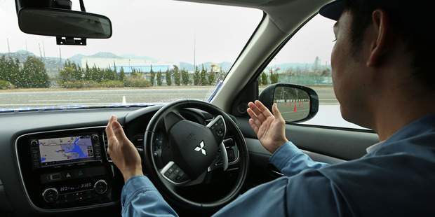 Mitsubishi Electric Corp. employee demonstrates the company's self-driving vehicle in Japan. Photo / Bloomberg.