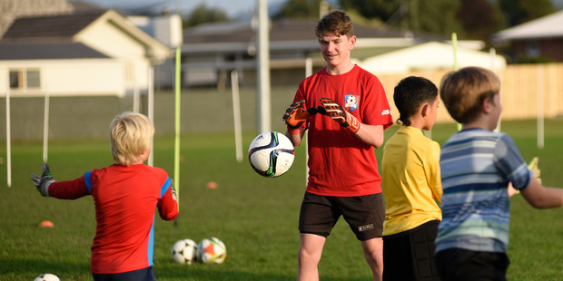 Ben Whitaker helps at a coach session for 50 young goalkeepers run by James Bannatyne. Photo/George Novak