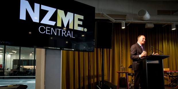 Prime Minister John Key at the opening of NZME's new Auckland headquarters last year. Shares in the company's parent - APN are in a trading halt pending an announcment. Photo / NZ Herald.
