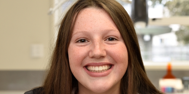 Ella shows off her orthodontic hardware and its result.