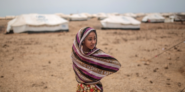Ashwaq, 12, stands outside her family's tent, at the Markaze refugee camp in Obock, northern Djibouti. Photo / AP