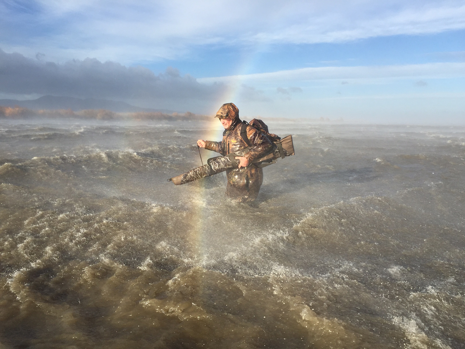 Duckshooter Andy Tannock of Palmerston North struggling through waves as he abandons his maimai on Lake Wairarapa after storm force winds hit the region.
Photo / Mark Mitchell