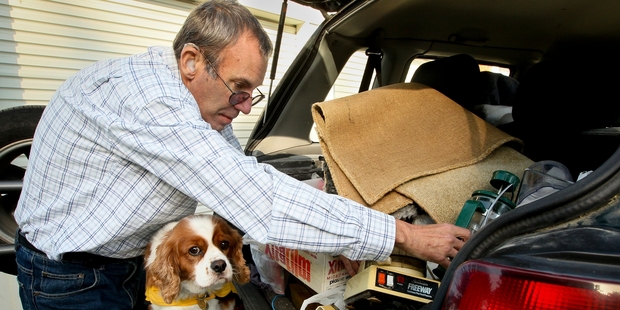 Murray Wittinghton and his hearing service dog Frodo pack up ready for the move into their new flat in Taradale. Photo / Warren Buckland