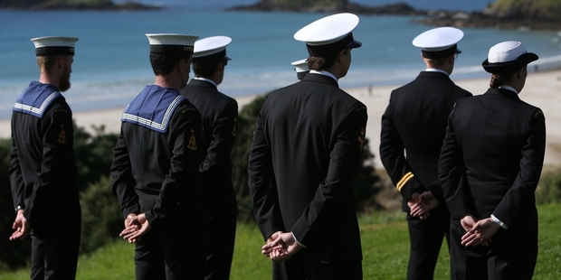 Naval officers, with Ocean Beach in the background.