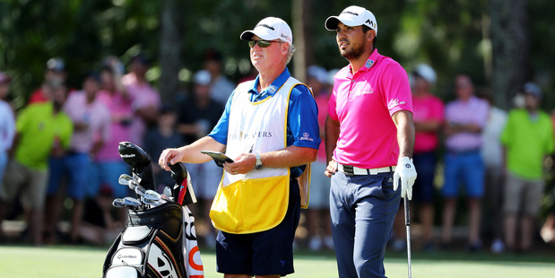 Jason Day and caddie Colin Swatton chat during the PLAYERS Championship. Photo / Getty Images