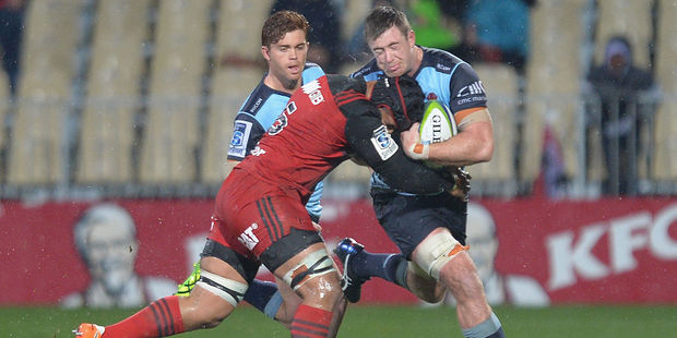 Jed Holloway of the Waratahs is tackled by Jordan Taufua of the Crusaders. Photo / Getty