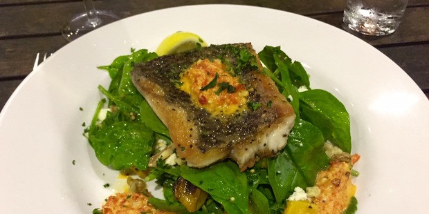 Barramundi with harissa dressing, spinach and feta, served up at Barefoot Art Food Wine in Horseshoe Bay, Magnetic Island.