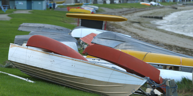 Catamarans and dingys were flipped and damaged in high winds last night along Pilot Bay. Photo/John Borren