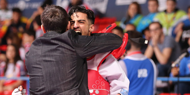 Mourad Laachraoui , right, celebrates after winning his fight at the European taekwondo Championships to earn his place in Belgium's Olympic team. Photo / AP