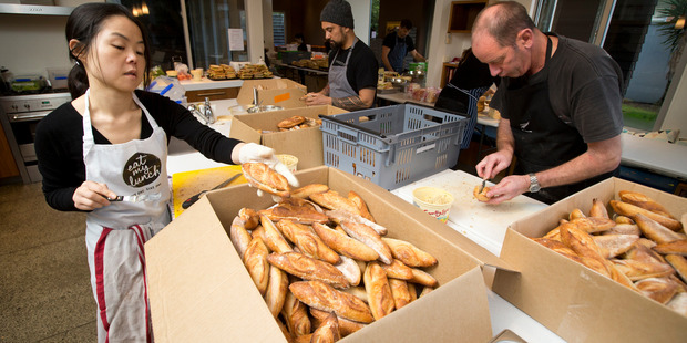 Lisa King, left, Chef Michael Meredith, centre, and Bruce Begg, right from Eat My Lunch, busy making hundreds of lunches from a house in Mt Eden.