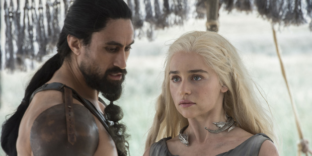 Joe Naufahu and Emilia Clarke in a scene from Game of Thrones.