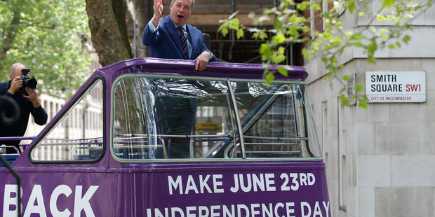 Leader of the Ukip Party Nigel Farage waves from the top of an open top bus in London as part of his party's campaign for Britain to leave the EU. Photo / AP