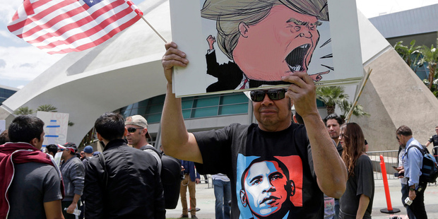 Mike Davis holds a sign during a protest outside rally for Republican presidential candidate Donald Trump at the Anaheim, California, Convention Centre. Photo / AP