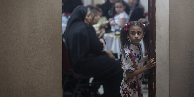 A young girl watches on as friends and relatives attend a memorial service for EgyptAir pilot Mohamed Said Shoukair. Photo / Getty Images