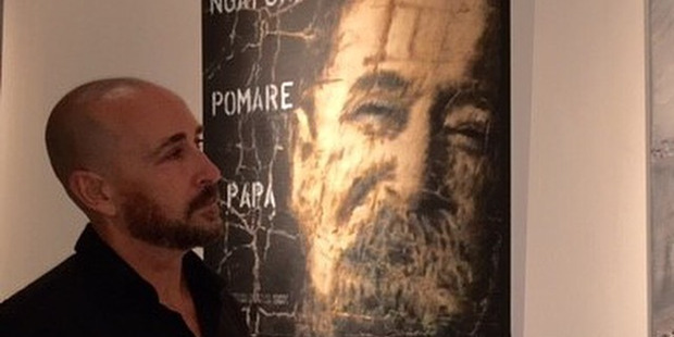 Auckland man Terry Fergusson, at his exhibition featuring a portrait of his great grandfather Hudson Pomare Fergusson, whose ashes were shifted from a crematorium wall into a vault. Photo / Supplied