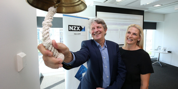 AFT Pharmaceuticals Managing Director Hartley Atkinson rings the bell to signal his company sharemarket listing on the NZX, with wife Maree Atkinson. Photo / Getty Images
