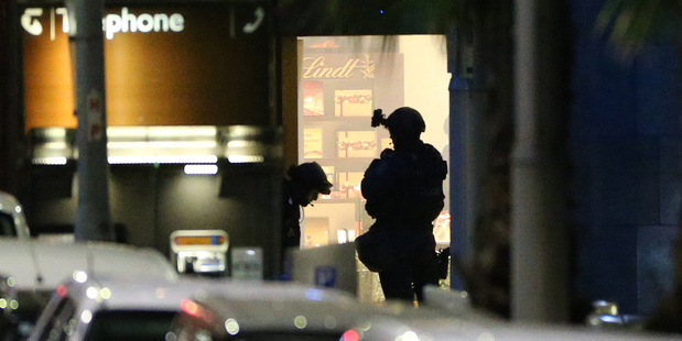 A police tactical adviser described Man Haron Monis' hostages as 'jovial' and casual' during handover notes. Photo / AP