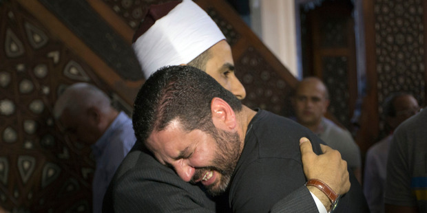 The Imam of al Thawrah Mosque gives condolences to film director Osman Abu Laban who lost four relatives on the EgyptAir plane crash. Photo / AP