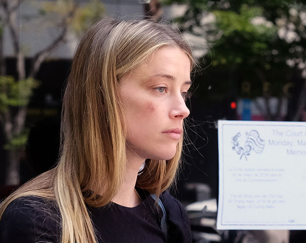 Amber Heard leaves court after giving a sworn declaration that her husband Johnny Depp threw her cellphone at her during a fight, striking her cheek and eye. Photo / AP
