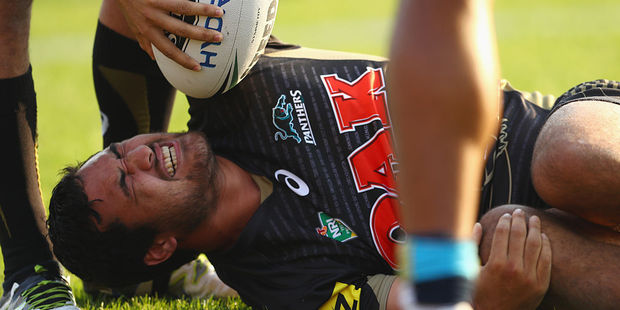 Peta Hiku of the Panthers grimaces as he lies on the ground with an injury. Photo / Getty
