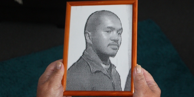 Liz Crean holds a photograph of her son Christopher. PHOTO: ILONA HANNE