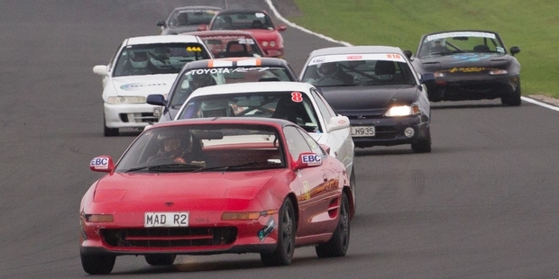 Whangarei racer Oscar Drummond leads the field in one of the 2K Cup motorsport races, and with his trophy for coming fifth.