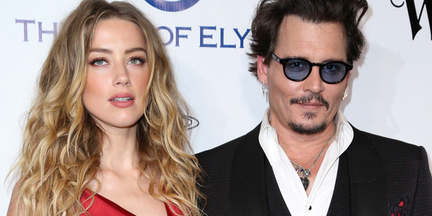 Amber Heard with her husband, Johnny Depp. She has filed for divorce, alleging abuse. Photo/AP