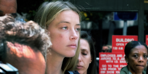 Amber Heard leaves court after giving a sworn declaration that her husband Johnny Depp threw her cellphone at her during a fight. Photo/AP