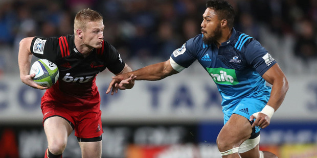 Johnny McNicholl of the Crusaders is tackled by George Moala of the Blues. Photo / Getty Images.
