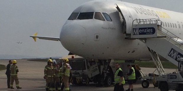 The tow truck was photographed crushed under the plane's nose. Photo / @OxBlueBilly, Twitter
