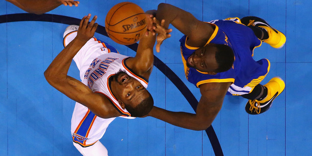 Oklahoma City Thunder's Kevin Durant (left) tussles for possession with Golden State Warriors' Draymond Green. Photo / Getty Images
