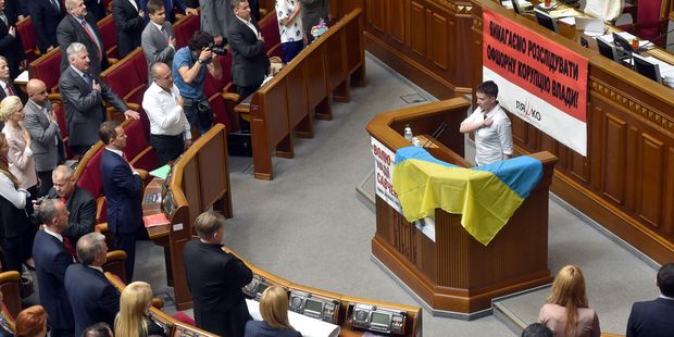 Ukrainian pilot Nadiya Savchenko and Ukrainian MPs sing the national anthem at the Ukrainian Parliament in Kiev. Photo / Getty
