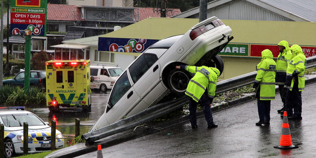 A car ended up over railing on Portal St in Whanganui this morning. Photo/ Stuart Munro