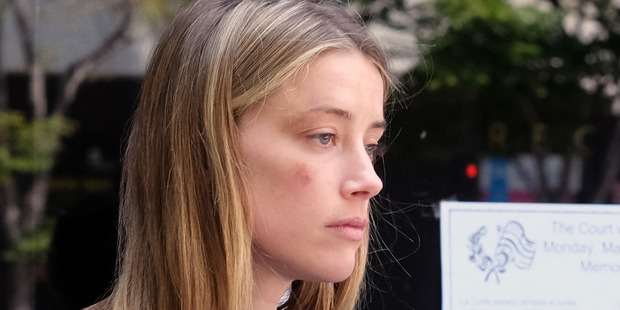 Actress Amber Heard leaves Los Angeles Superior Court after giving a sworn declaration that her husband Johnny Depp threw her cellphone at her during. Photo / AP