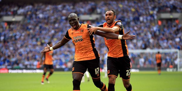 Hull City's Mohamed Diame, left, celebrates scoring his side's first goal of the game with teammate Ahmed Elmohamady. Photo / AP.
