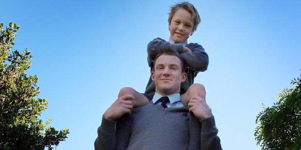 Wanganui Collegiate student Harry Unsworth gives St George's pupil Oliver Jones another lift up. PHOTO/STUART MUNRO