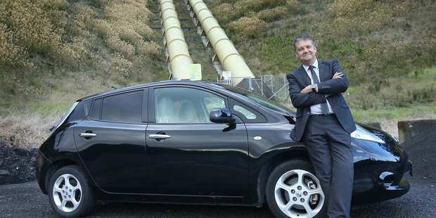 Have Electricity Must Drive. Ross Brown with his plug-in electric car, a Nissan Leaf. Photo/John Borren
