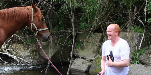 Ashley laughs after diving into a stream during equine therapy. Funding for the sessions was discontinued. Photo / Supplied