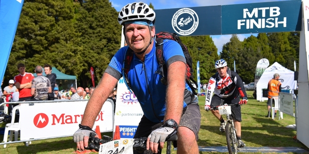 Aaron Watkin finishes the T42 mountain bike race in one piece after being airlifted to hospital the previous year. Photo / Allan Ure