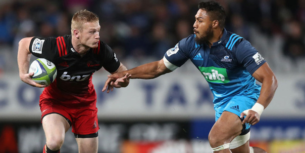 Johnny McNicholl of the Crusaders is tackled by George Moala of the Blues. Photo / Getty Images.
