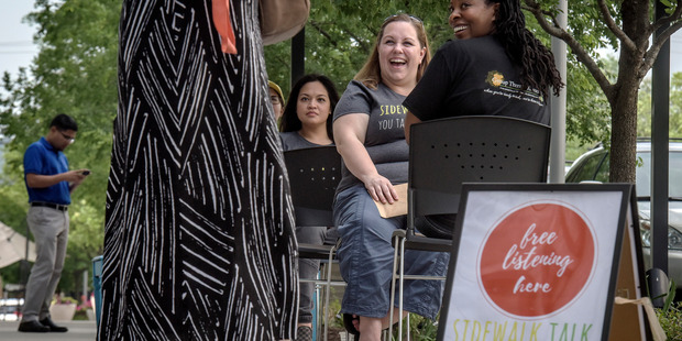 Volunteers, from left, Nicole Kwan and Rita Goodroe, and therapist Esther Boykin interact with passersby. Photo / Washington Post