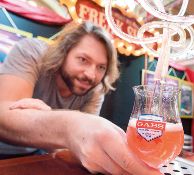 Jos Ruffell from Wellington's Garage Project mixes a brew at their 'Freak Show' stand. Photo / GABS