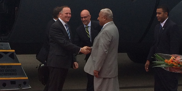 Prime Minister John Key shakes hands with Fiji Prime Minister Voreqe Bainimarama at Suva Airport. Photo / Claire Trevett