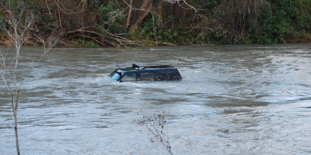 FLOODED ENGINE: A four-wheel-drive in the Ruamahanga River at Percy's Reserve in Masterton floats downstream. PHOTO/ALISA YONG