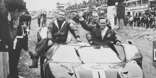 A jubilant Chris Amon waves to the crowd after he and Bruce McLaren won the 1966 24 Hours of Le Mans. Photo / AP