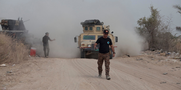 Iraq's elite counter-terrorism forces move their vehicles on the front line in Fallujah, Iraq. Photo / AP