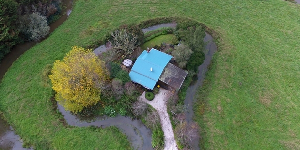 The property for sale in Clevedon is surrounded by a stream.