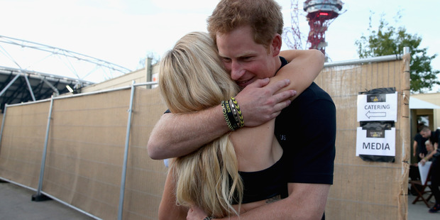 Prince Harry hugs Ellie Goulding backstage at the 2014 Invictus Games Closing Ceremony. Photo / Getty Images