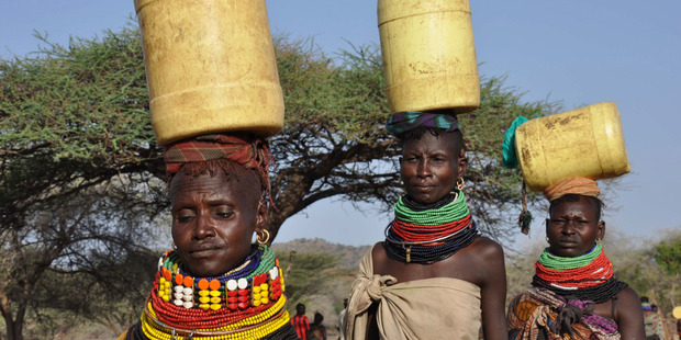 Turkana women carry home water taken from a borehole in a dry riverbed in northern Turkana, Kenya. Photo / AP